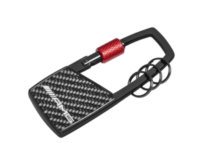 AMG snap-hook key ring. Black/red. Stainless steel/carbon fibre/aluminium. Snap-hook with twist action to open. Three additional mini split rings for quick removal/replacement of individual keys. Length approx. 10 cm.