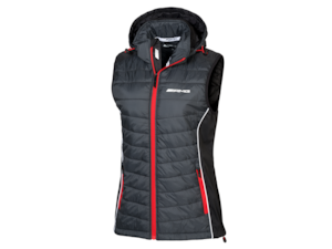 AMG ladies' gilet. Selenite grey/red/white. Outer fabric softshell 100 % polyester, body 100 % nylon with polyurethane coating, taffeta lining and lightweight wadding 100 % polyester. Windproof. Warm. Detachable hood. Water-resistant zip. High-closing collar with chin guard. Various pockets. Slim fit. Sizes XS-XL.